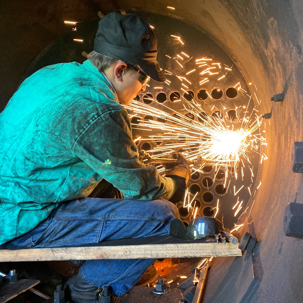 person working with sparks flying